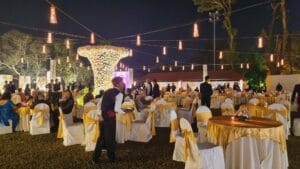 a group of people standing around tables and chairs in a Bengali catering Event Arranged by the Best Bengali Caterers in Kolkata Selection caterer